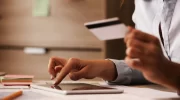 closeup-businesswoman-using-digital-tablet-credit-card-while-checking-her-online-bank-account